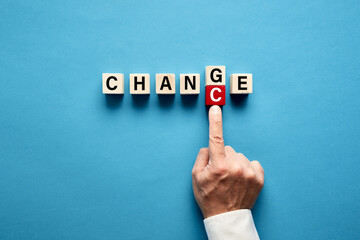 Businessman hand transforming the word Change into Chance written on wooden cubes
