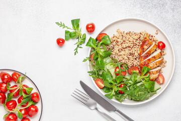 Turkey fillet or chicken, quinoa and vegetable salad in plate. Diet concept food. Top view.
