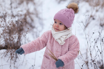 portrait of a beautiful little girl in a hat and scarf in winter. copy space. mock up for design