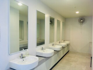Fototapeta na wymiar Interior basic of public restroom have classic washbowl and white clean design