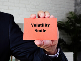 Business concept meaning Volatility Smile with inscription on the piece of paper.