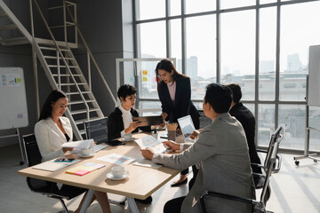 attractive woman present her analysis to young lady team leader  in business meeting with diversity people at modern office room, young power, woman leadership concept