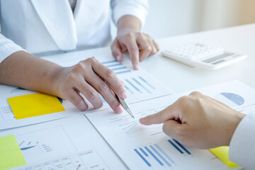 businesswoman and businessmen team meeting to plan strategies to increase business income. Have a brainstorming graph analysis and discussing for the new target success