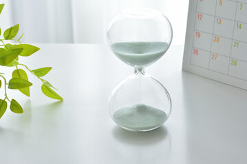 Hourglass on a white desk