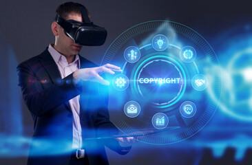 Business, Technology, Internet and network concept. Young businessman working on a virtual screen of the future and sees the inscription: Copyright