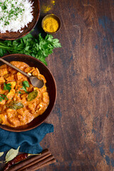 Spicy chicken tikka masala with bioled rice . Top view with copy space.