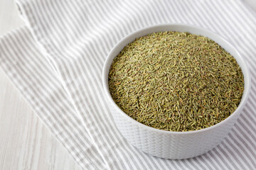 Organic Dried Rosemary in a Bowl, low angle view. Copy space.
