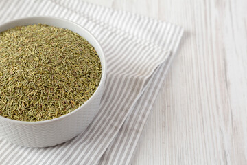 Organic Dried Rosemary in a Bowl, low angle view. Space for text.