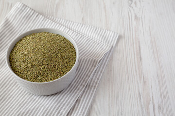 Organic Dried Rosemary in a Bowl, low angle view. Copy space.