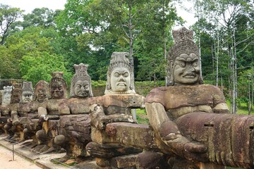 Row of demons statues in the South Gate of Angkor Thom complex, Siem Reap, Cambodia