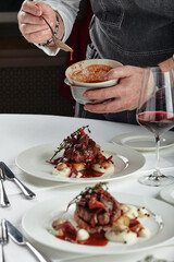 Beautifully decorated catering banquet table with different food snacks and appetizers. chef puts a dish on the table