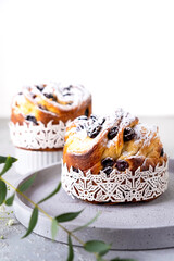 Easter cake kraffin. Craffins with raisins, candied fruits and sprinkled with powdered sugar. Close-up of homemade pie. Cruffin.