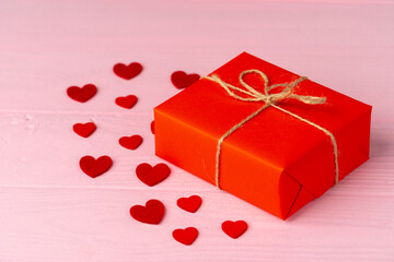 Wrapped gift for Valentine's day on wooden table