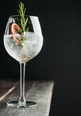 Gin based cocktail with triple sec in wine glass on the rustic background. Selective focus. Shallow depth of field. 