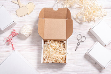 White cardboard carton box on wooden desk, flat lay mock up