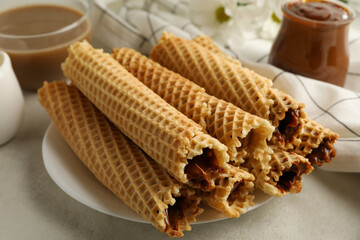 Concept of tasty breakfast with wafer rolls with condensed milk