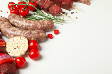 Set of different raw barbecue meat on white background, space for text