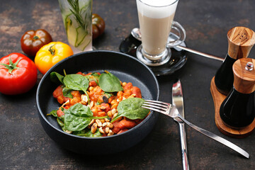 Tomatoes baked with spinach and peanuts.
Food served on a plate, food styling, serving suggestions, culinary photography.
