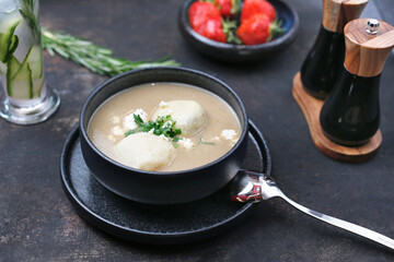 Cream soup. Creamy white vegetable soup.
Food served on a plate, food styling, serving suggestions, culinary photography.