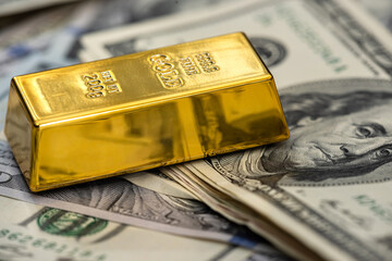 Gold bullion with us money for design close up