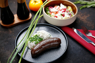 Black pudding, poached egg and cottage cheese. Food served on a plate, food styling, serving...