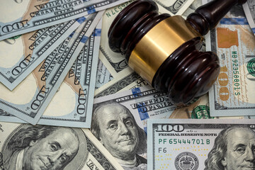 Wooden gavel on american dollars bills