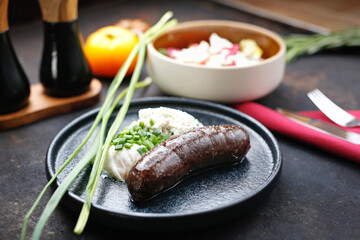 Black pudding, poached egg and cottage cheese. Food served on a plate, food styling, serving...
