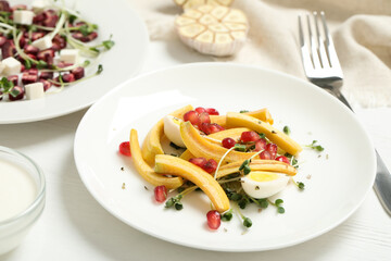 Delicious fresh carrot salad served on white wooden table, closeup