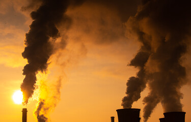 Clouds of smoke from a thermal pipe during an amazing winter freezing sunrise environmental global warming