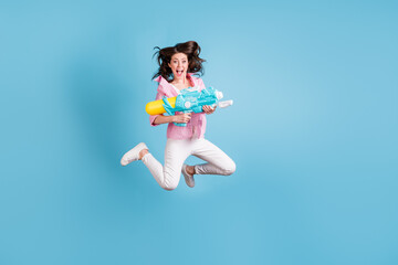 Full length portrait of playful lady jum hold water weapon open mouth wear pants shoes isolated on...