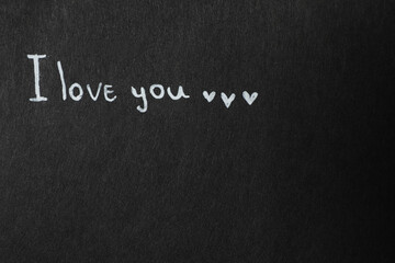 Phrase I Love You on black background. Space for text