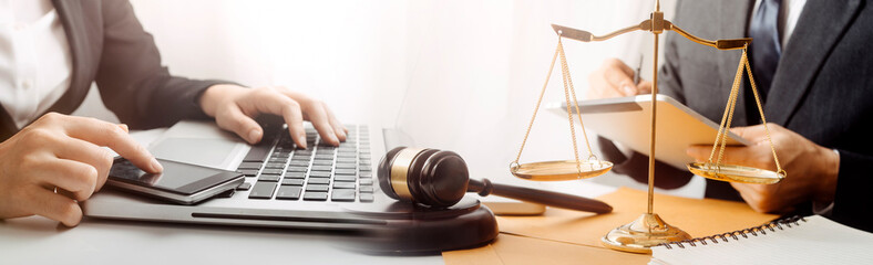 Business and lawyers discussing contract papers with brass scale on desk in office. Law, legal...