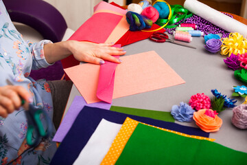 Fototapeta premium Woman modelling artificial flower from clay