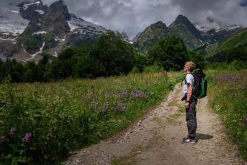 Fototapeta na wymiar Man with backpack hiking in mountains. Travel Lifestyle success concept