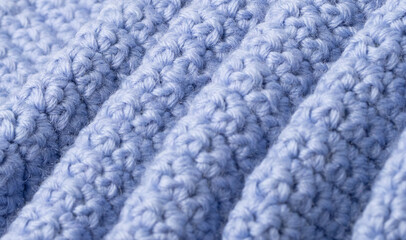 close-up of knitting of front and back loops on a lilac textured woolen background. Handicraft concept.