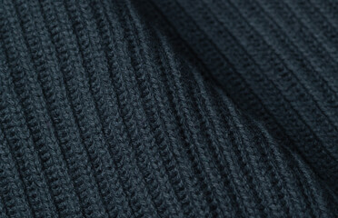 knitted textured background of dark gray color. Close-up of knit and purl loops.