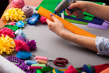 Woman modelling artificial flower from clay