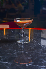 Chocolate cocktail with lemon slices in tall glass on a black table. Eating out in restaurant concept.