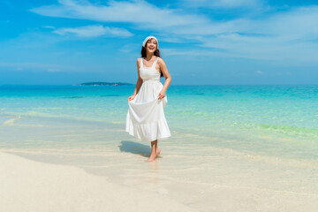 Fototapeta na wymiar cheerful woman on sea beach at Koh MunNork Island, Rayong, Thailand