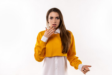 Worried and concerned brunette girl cover opened mouth palm and looking with frightened expression