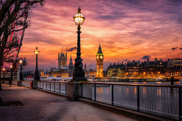 The London Southbank riverside of the Thames with view to the Big Ben clocktower and Westminster Palace during a colorful sunset, United Kingdom