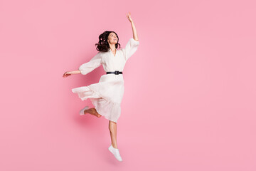 Full length body size photo of cheerful happy girl jumping up like ballerina looking empty space...