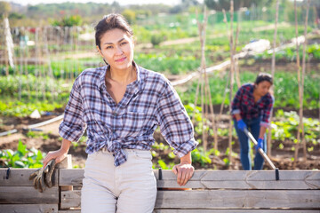 Portrait of asian village girl near farm fence