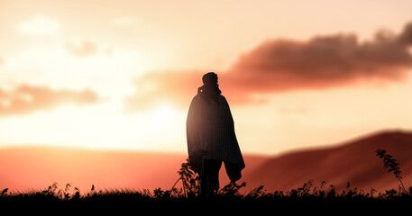 a silhouette of tribe men walks in outdoor at evening sundown.