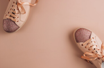 Pink women sneakers on a pink background. Flat lay of modern shoes. Fitness and healthy, life style...