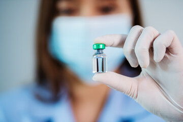 doctor holding vaccine bottle for injection medicine