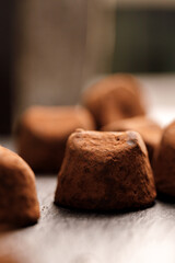 Chocolate truffel candy on black surface close up