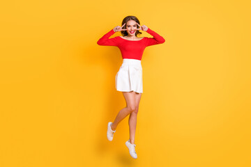 Full length body size photo girl wearing fashion clothes smiling showing thumb-up sign both hands isolated on bright yellow color background