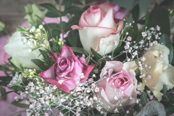 Flower bouquet with pink and white roses on wooden background