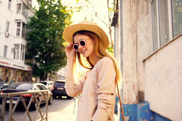 Fototapeta premium woman in hat walking in the city sunny day lifestyle